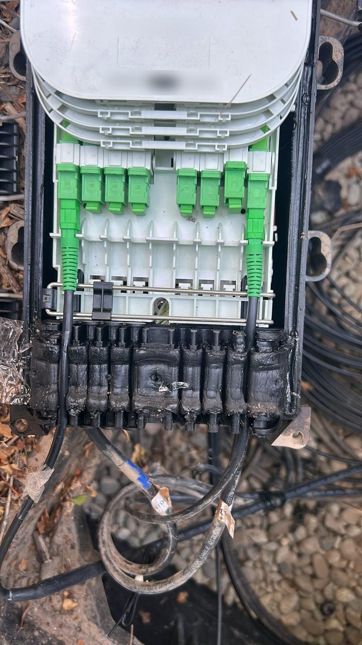 Service documentation showing outdoor fiber distribution unit for customer drops with tools or ports visible