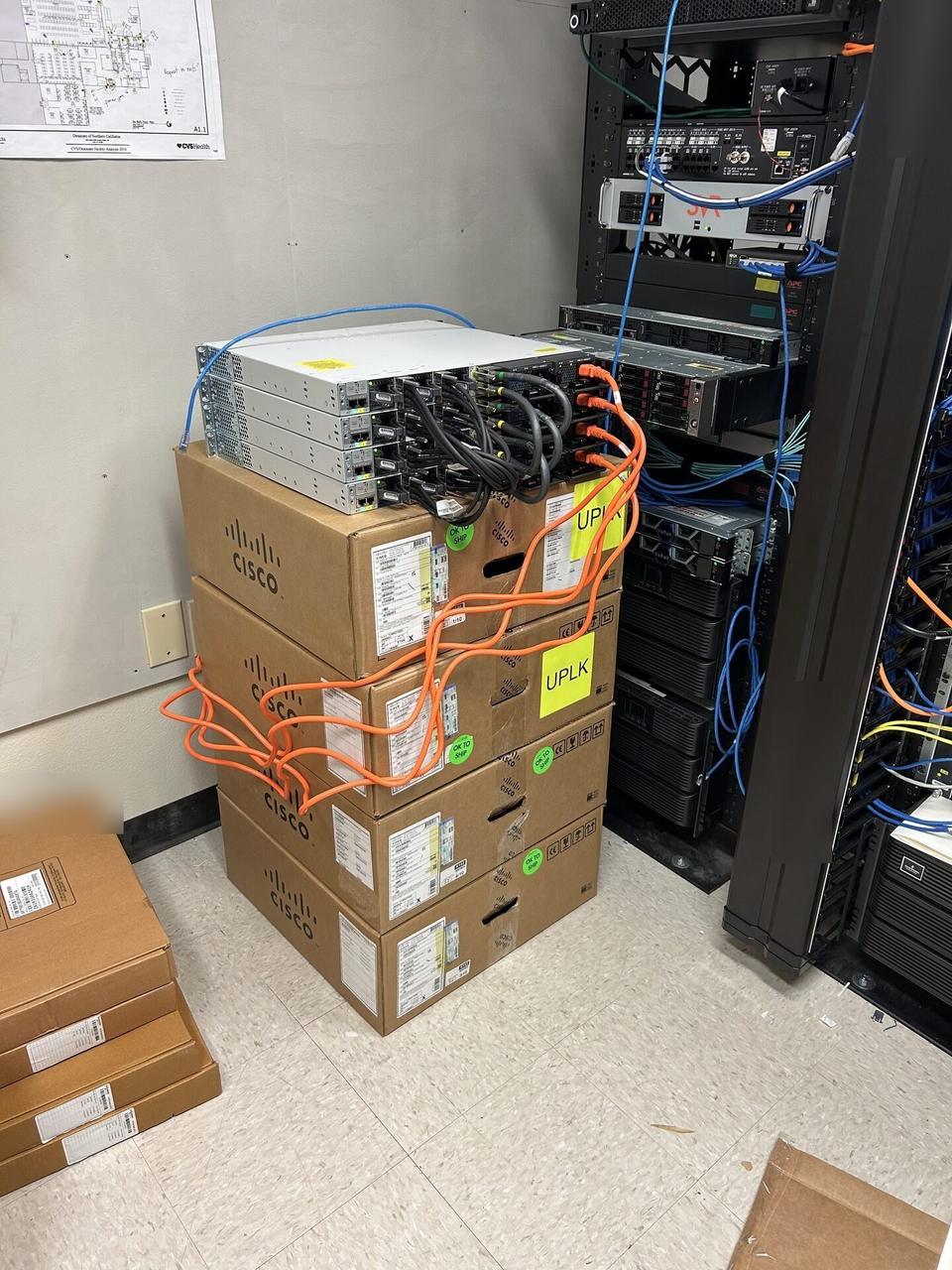 Server-room preparation of four Cisco routers for a routed network equipment handoff