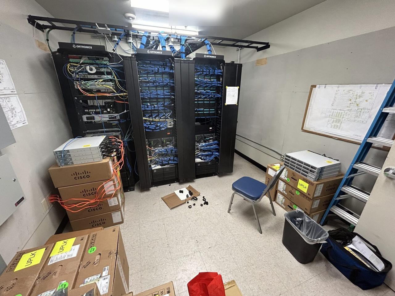 Alrty field photo with structured cabling inside a network rack during network hardware support