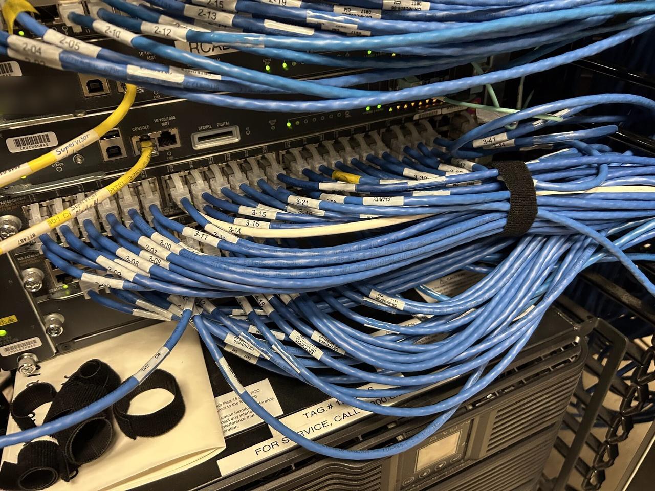Public-safe portfolio image of structured cabling inside a network rack with rack cabling organized