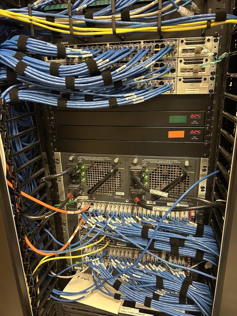 Network rack and patch panel cabling inside the equipment cabinet documented for a smart technology service call