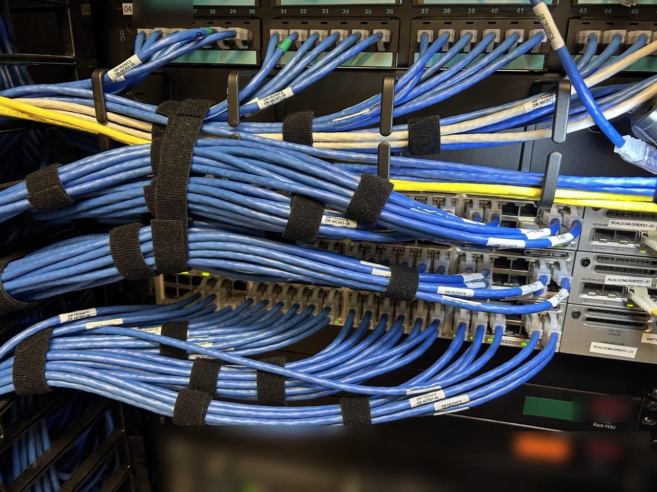Onsite service photo showing structured cabling inside a network rack with structured cabling visible