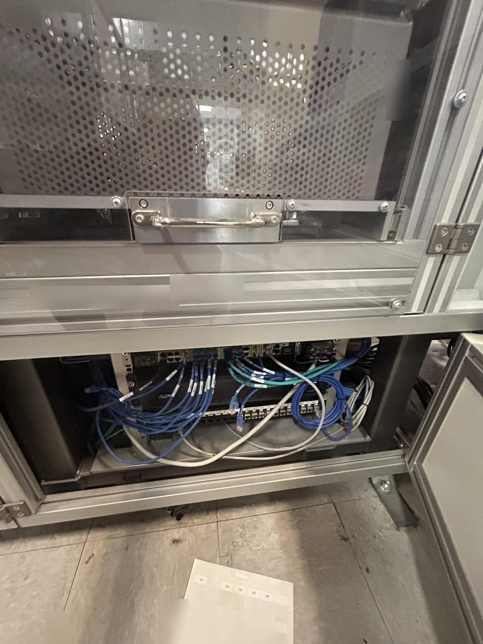 Onsite service photo showing rack-mounted network hardware during service before final connectivity checks