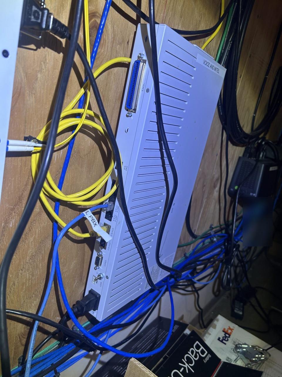 Structured cabling inside a network rack at the server-room handoff point documented for a smart technology service call