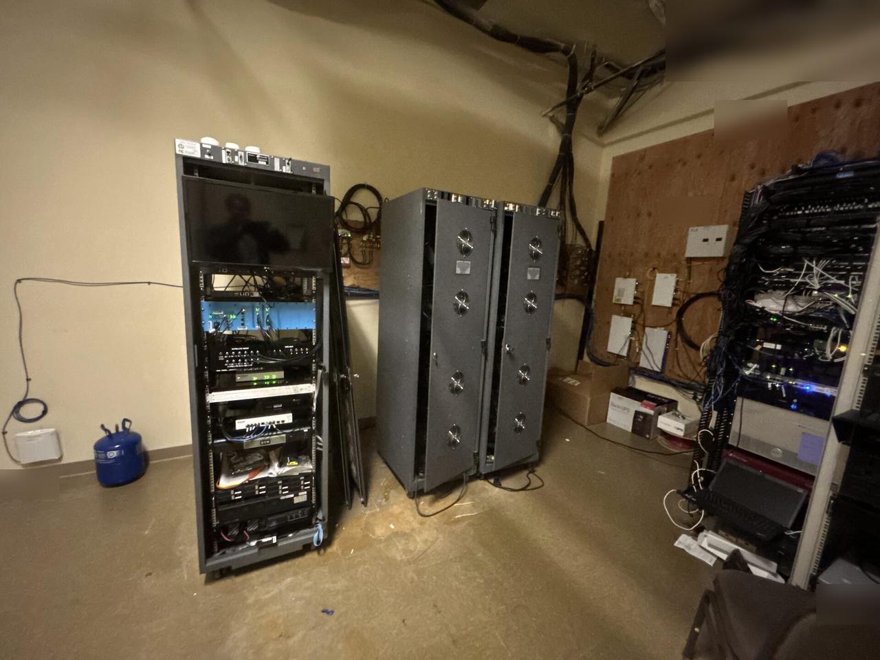 Alrty portfolio view of rack-mounted network hardware during service with structured cabling visible