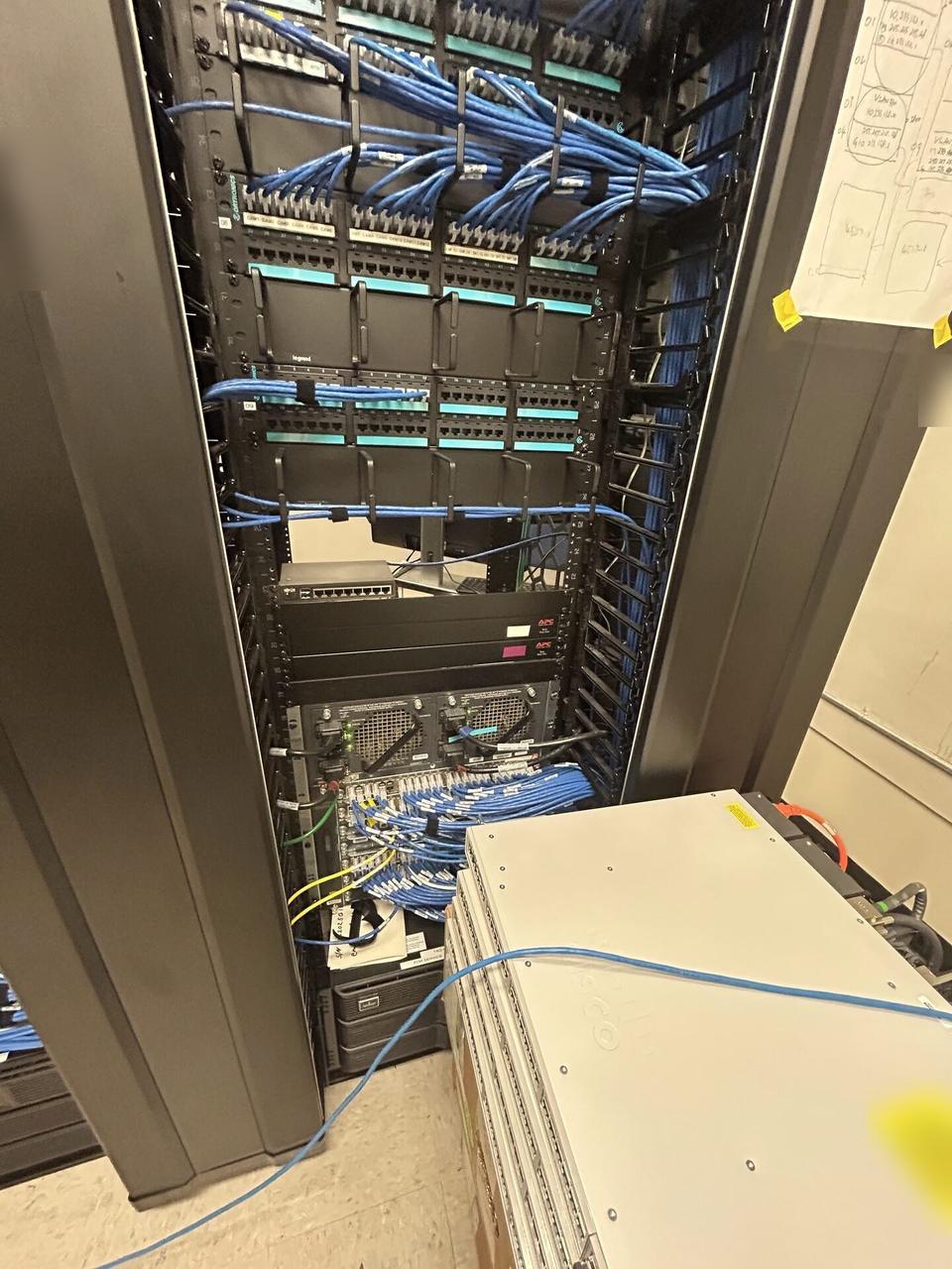 Equipment cabinet cabling and switch handoff with structured cabling visible documented for a smart technology service call