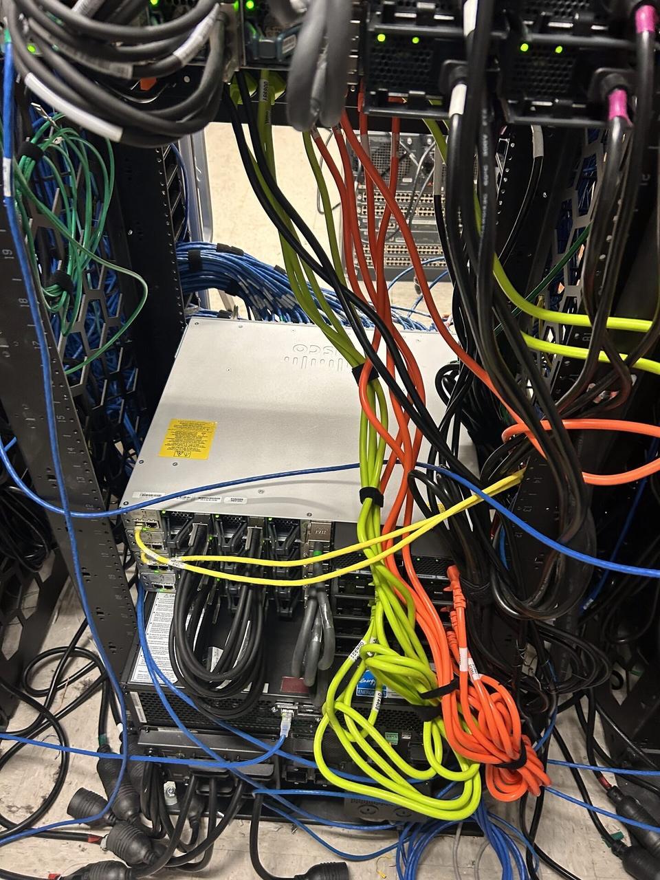 Onsite service photo showing structured cabling inside a network rack during network hardware support