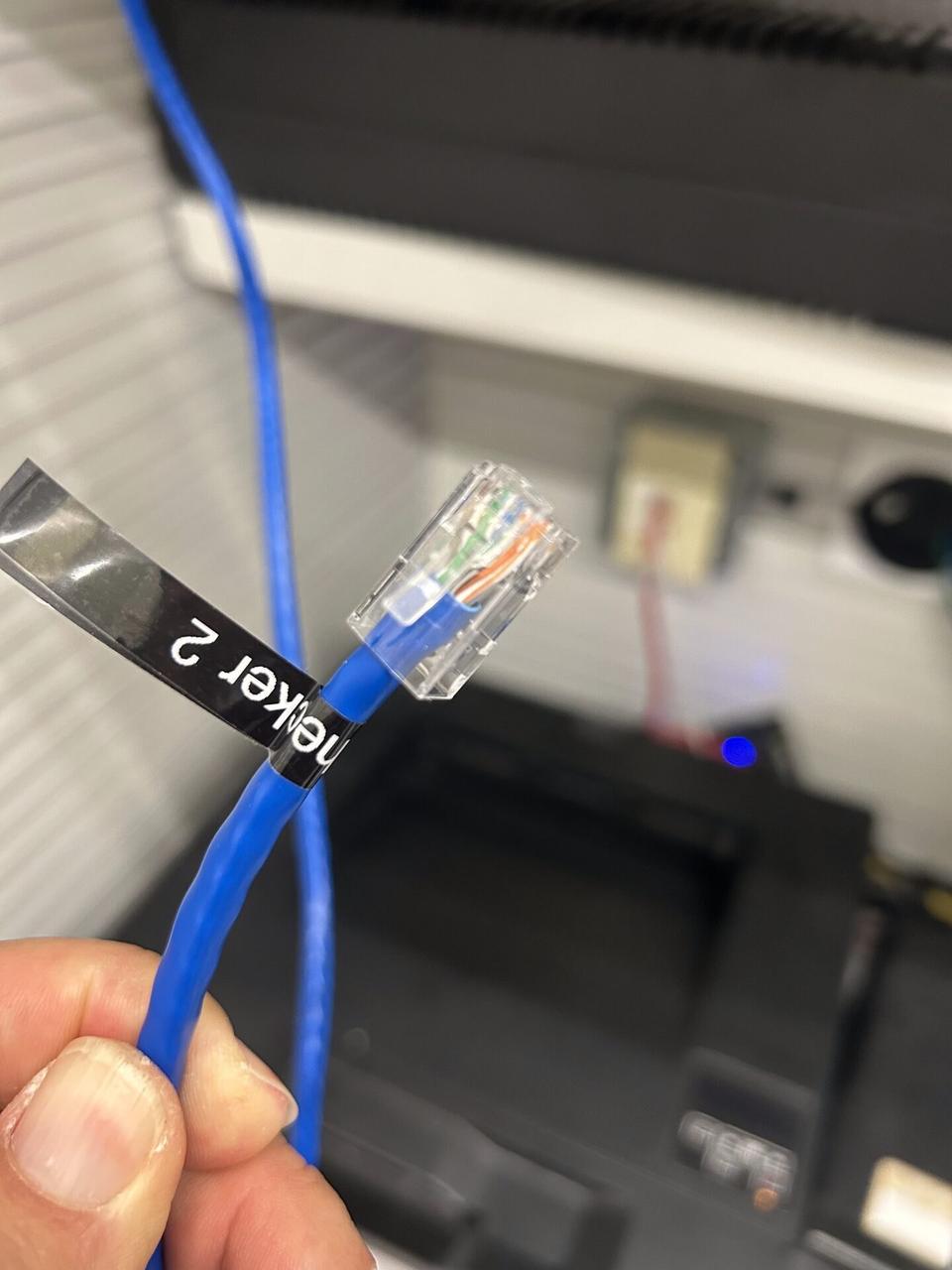 Onsite service photo showing low-voltage device wiring documented onsite before trim-out or final setup