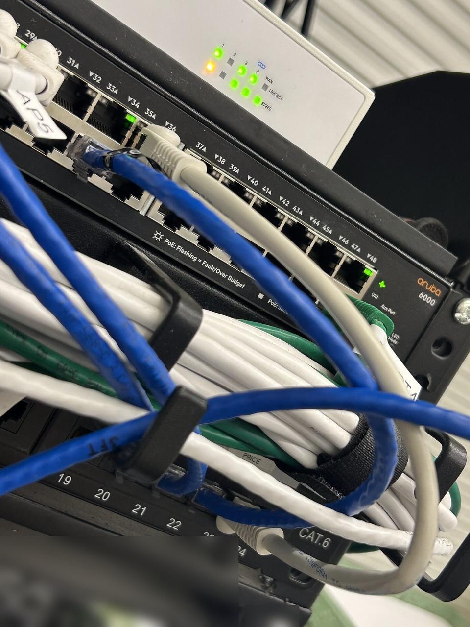 Public-safe portfolio image of low-voltage hardware and device cabling during cable path verification