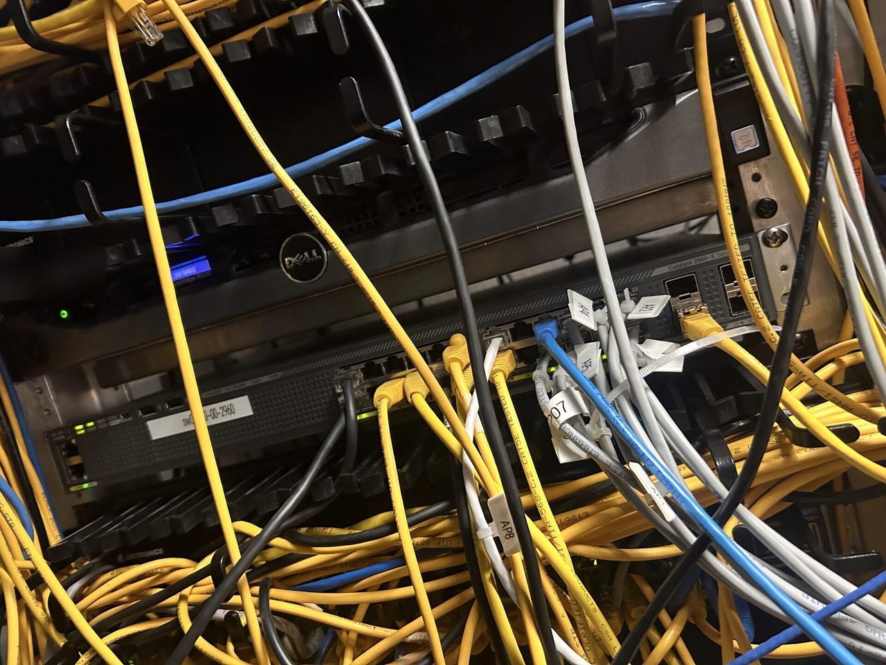 Public-safe portfolio image of rack-mounted network hardware during service inside the equipment cabinet