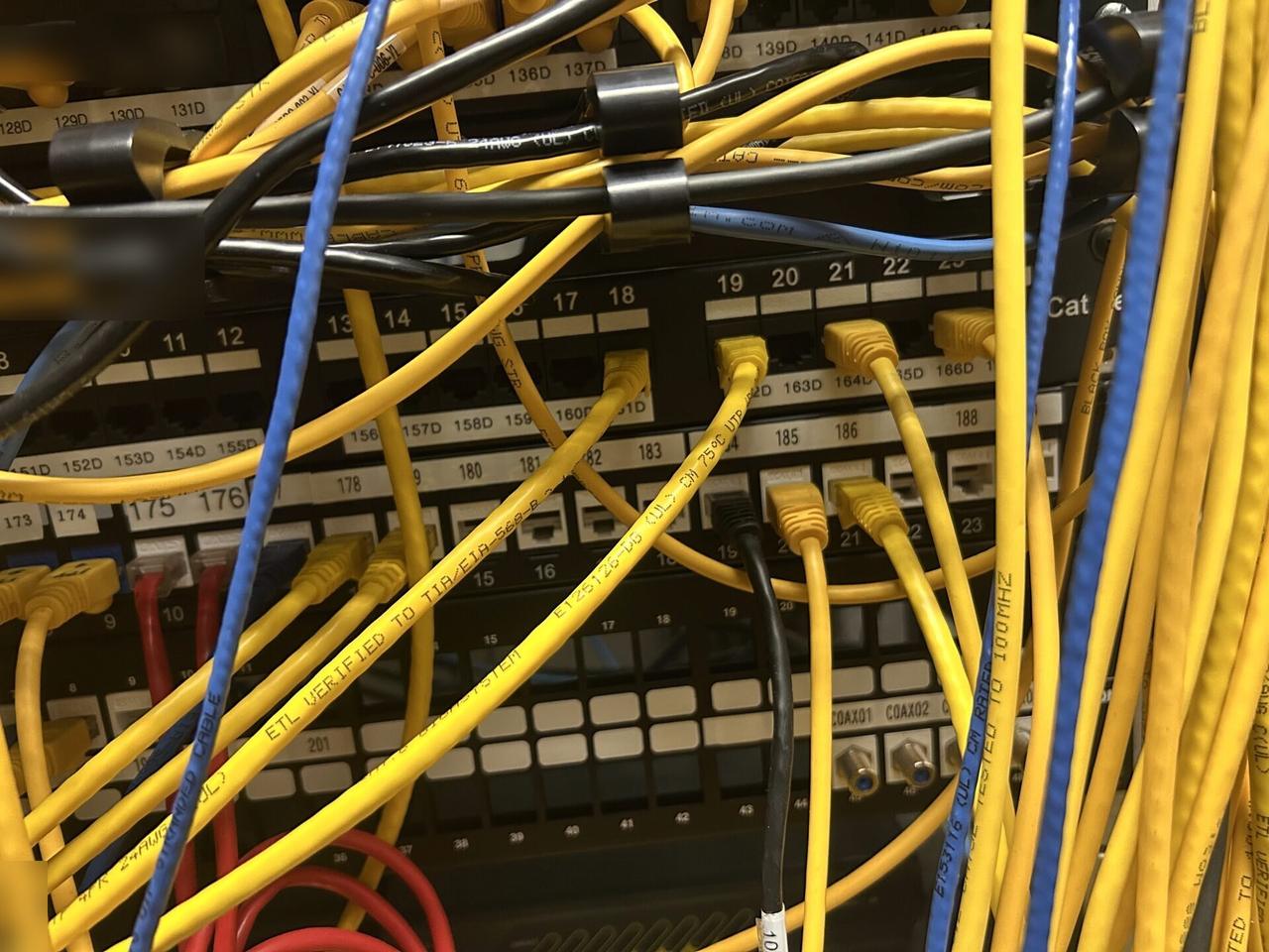 Onsite service photo showing rack-mounted network hardware during service inside the equipment cabinet
