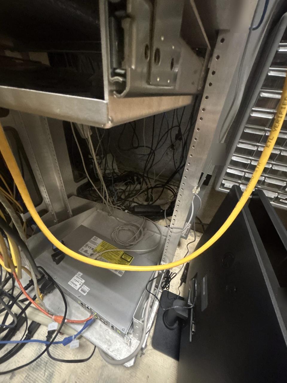 Rack-mounted network hardware during service with rack cabling organized documented for a smart technology service call