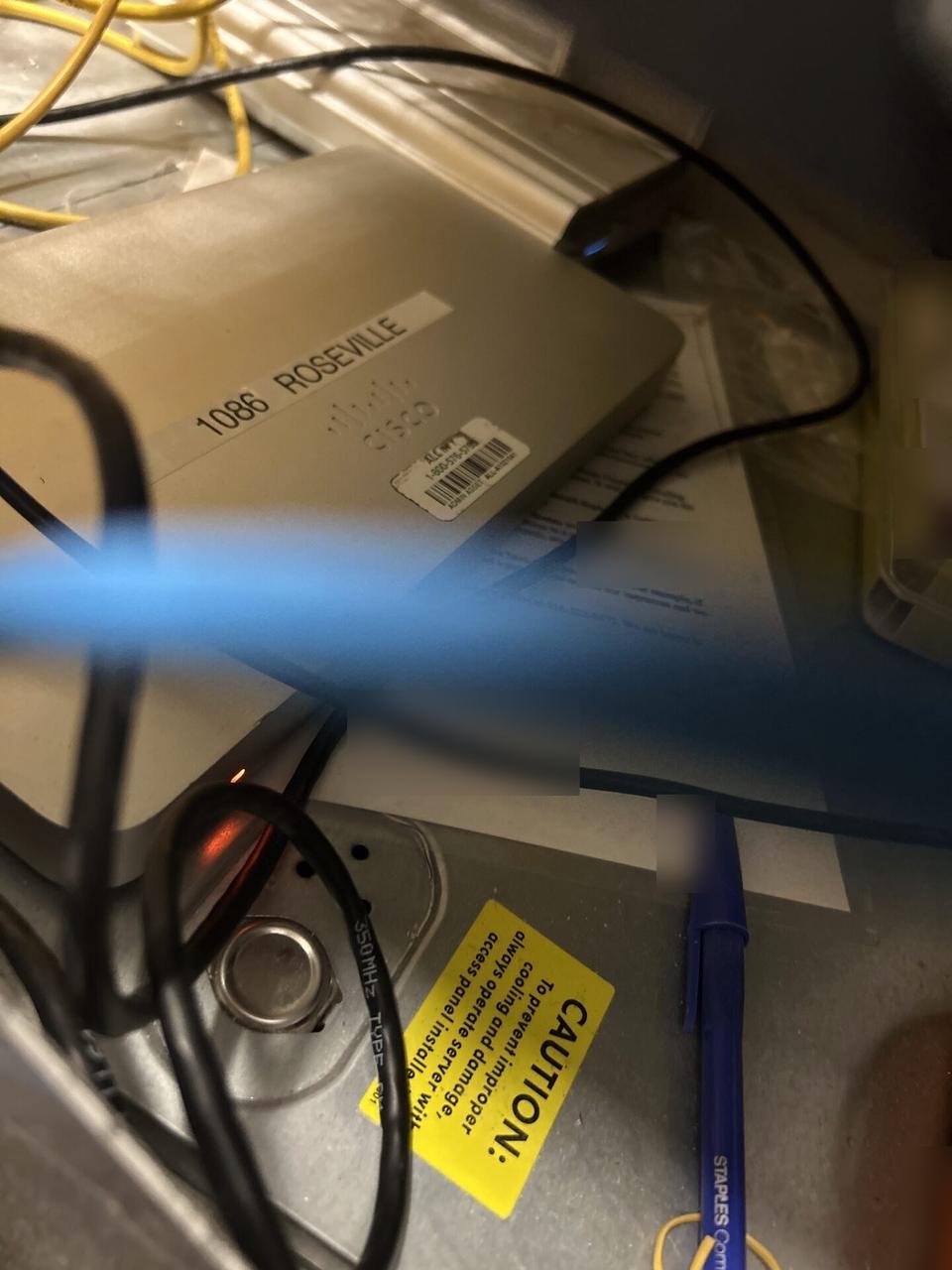 Onsite service photo showing server-room cabinet and structured network equipment with structured cabling visible