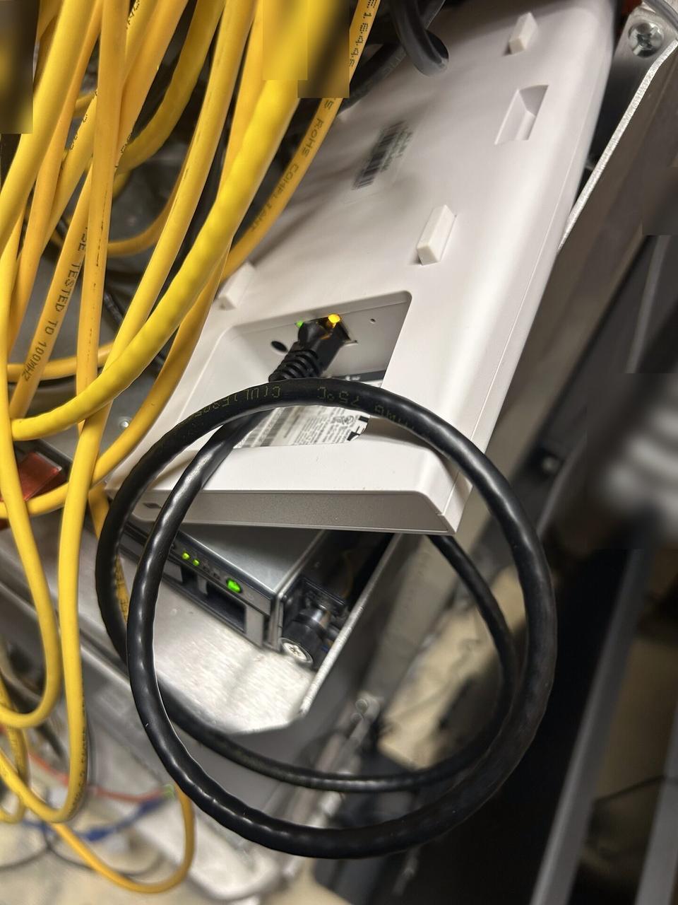 Alrty field photo with low-voltage hardware and device cabling during field wiring work