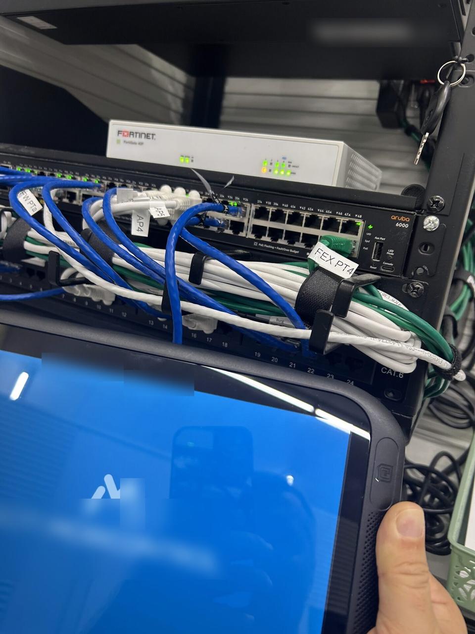 Public-safe portfolio image of low-voltage hardware and device cabling with wall routing visible