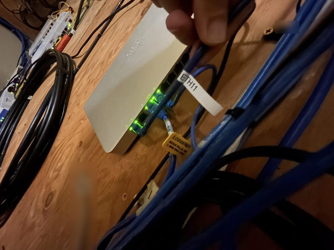 Rack-mounted network hardware during service with private labels omitted during an Alrty onsite service visit