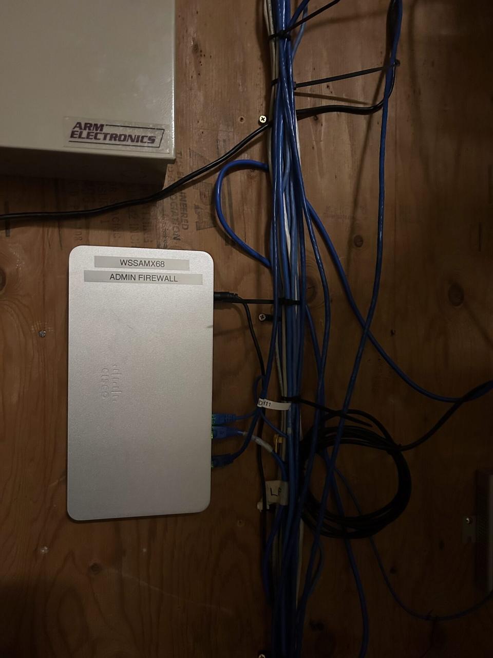 Onsite service photo showing network rack and patch panel cabling with structured cabling visible