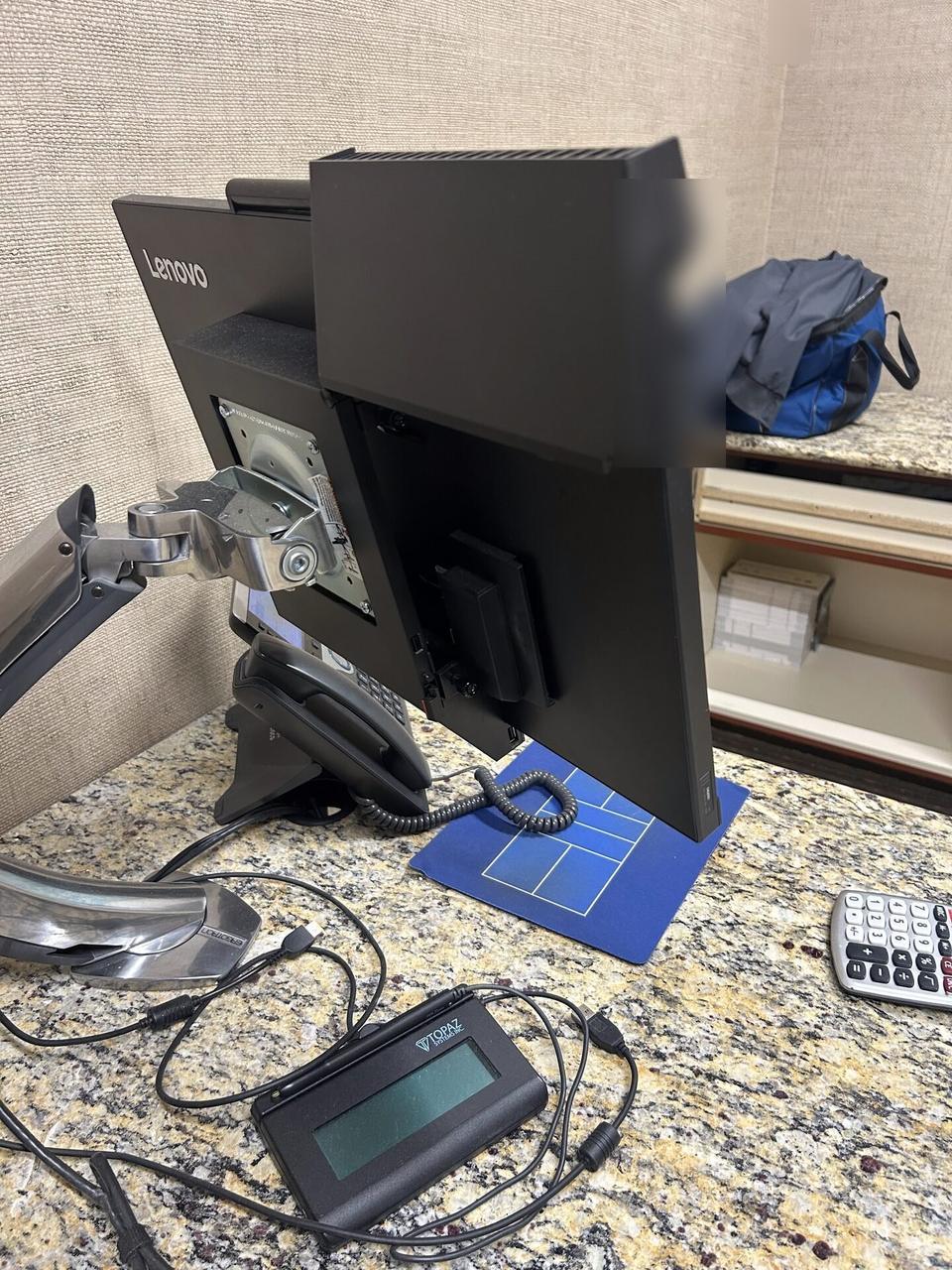 Office workstation setup with monitors with private screen details omitted documented for a smart technology service call