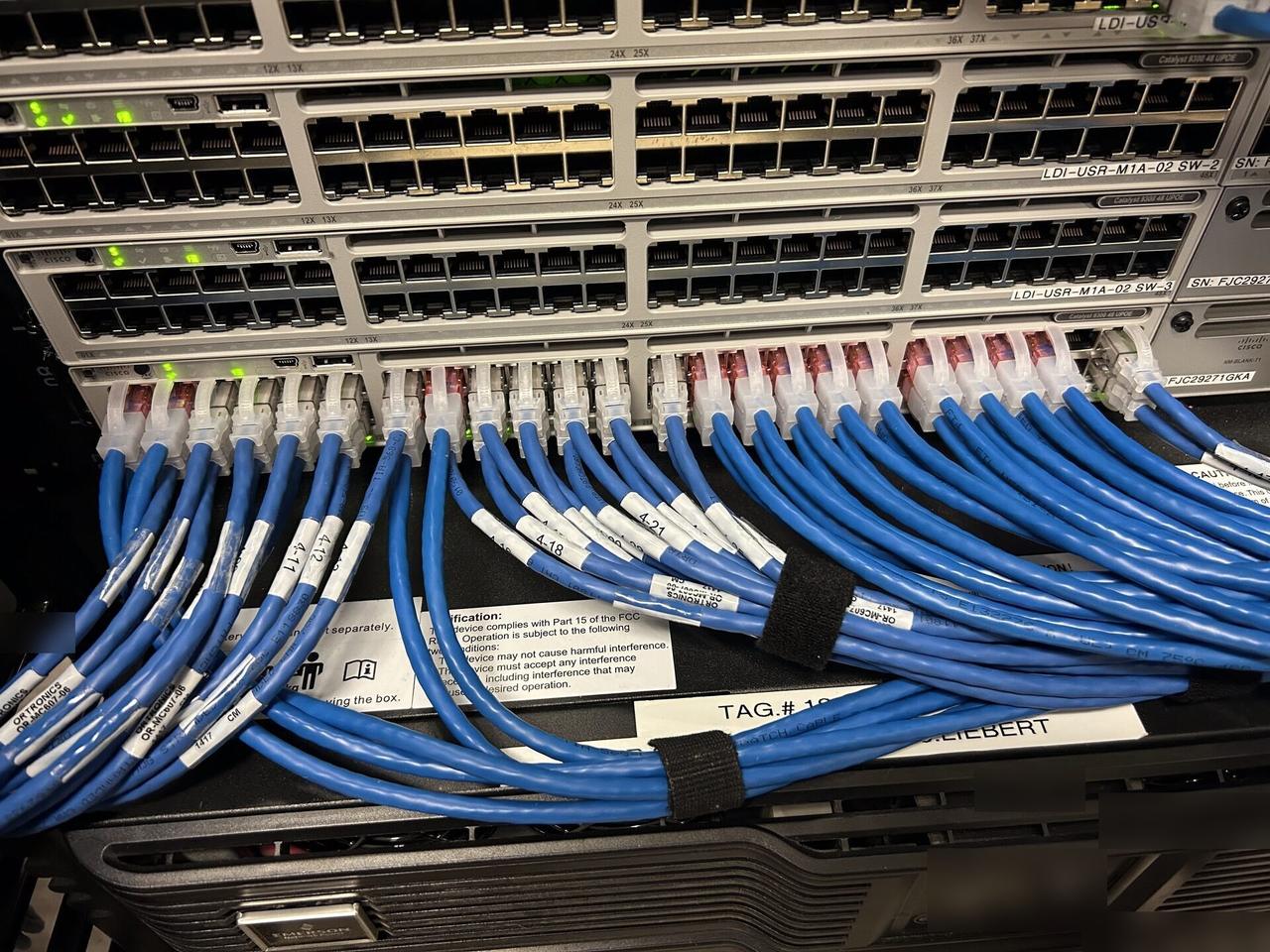 Public-safe portfolio image of rack or server-room network equipment with structured cabling visible