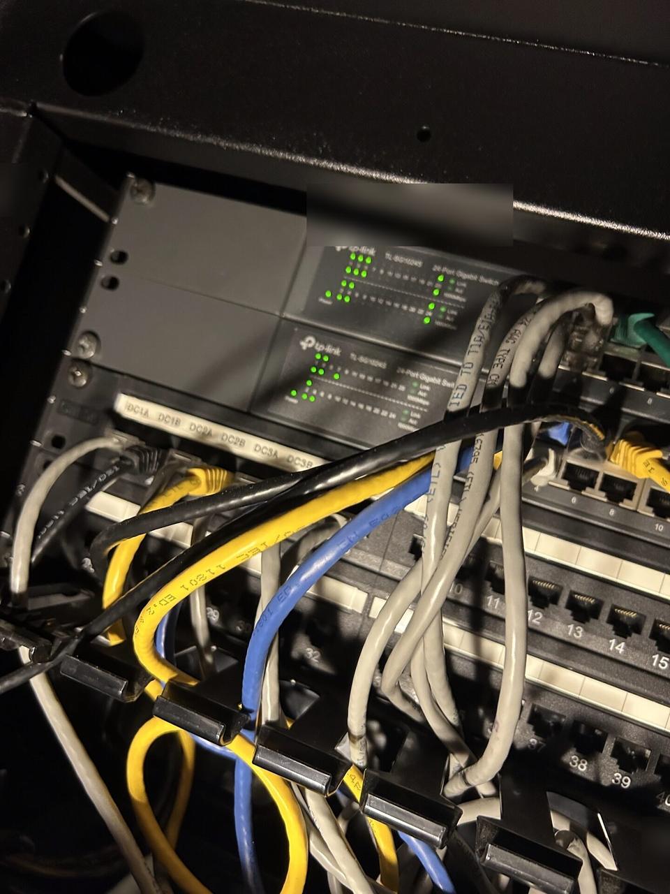 Server-room cabinet and structured network equipment with structured cabling visible documented for a smart technology service call