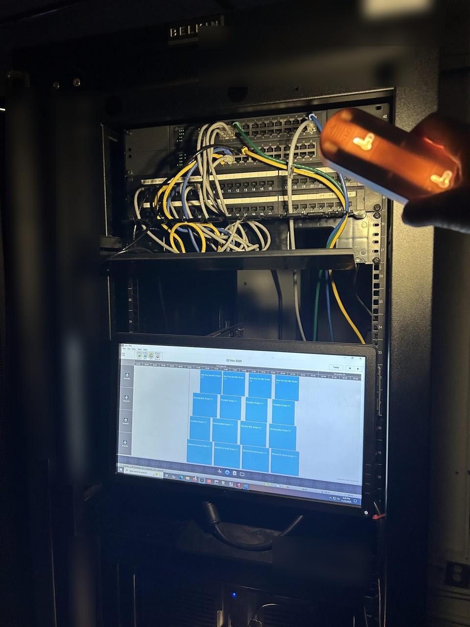 Onsite service photo showing structured cabling inside a network rack with private labels omitted