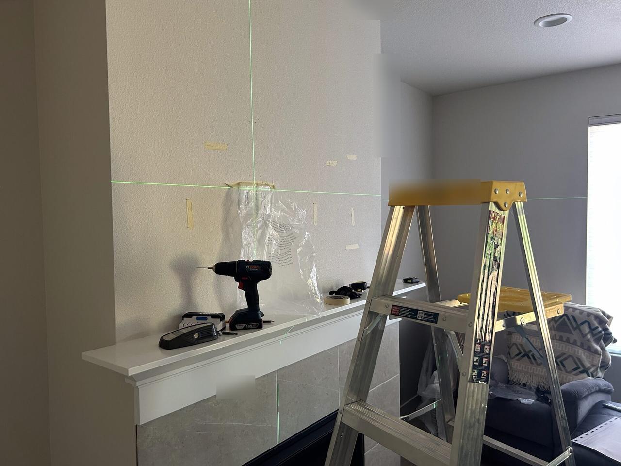 Onsite service photo showing TV mounting and display setup work during TV service preparation