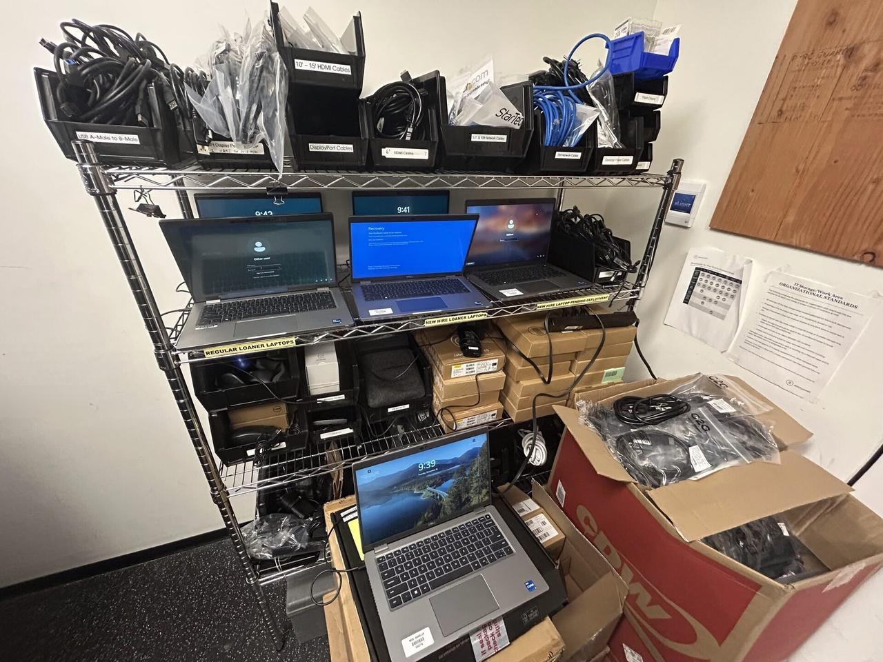 Alrty field photo with computer screen check during onsite workstation service with setup context visible