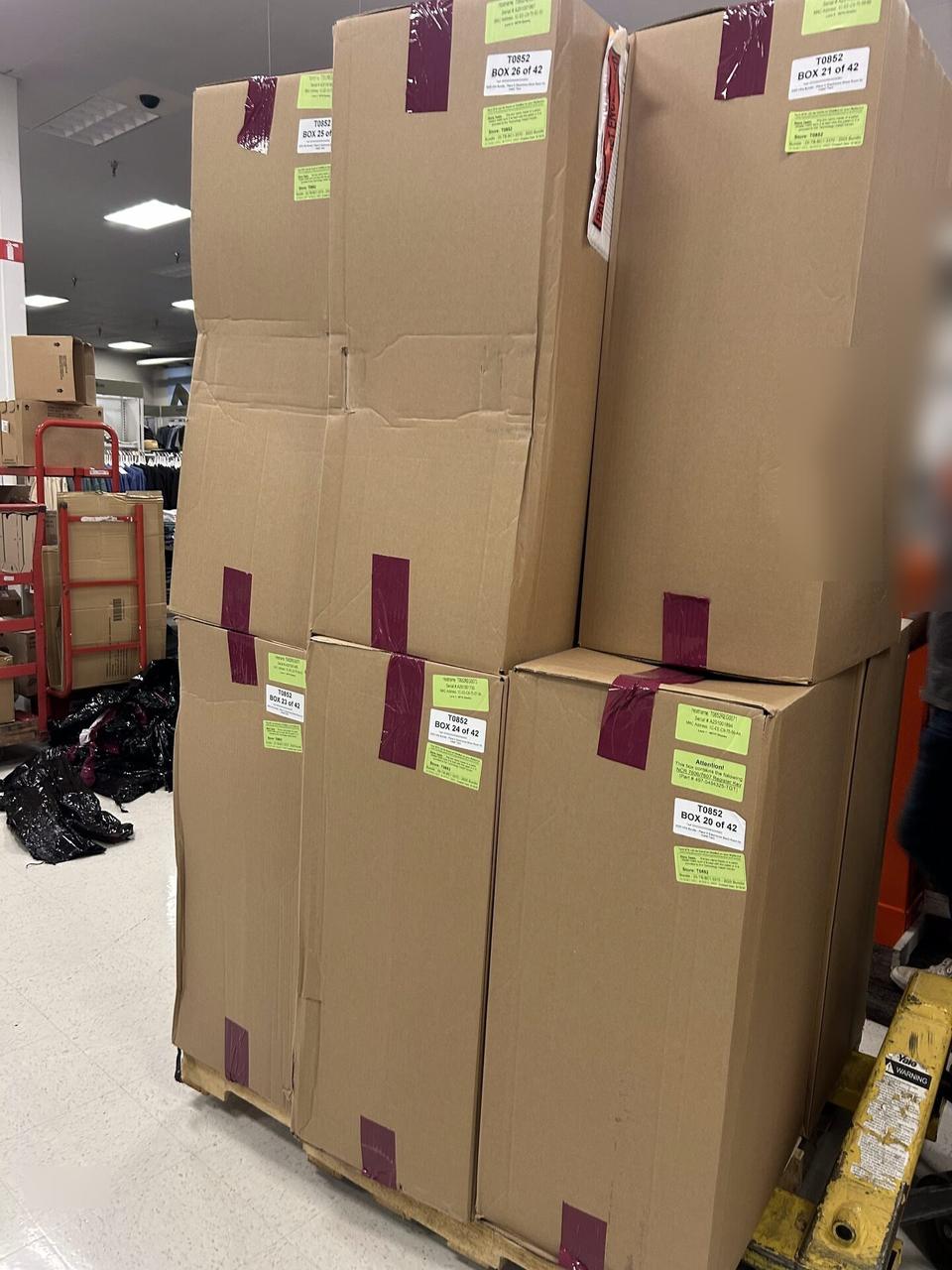 Onsite service photo showing stacked equipment boxes at a retail worksite