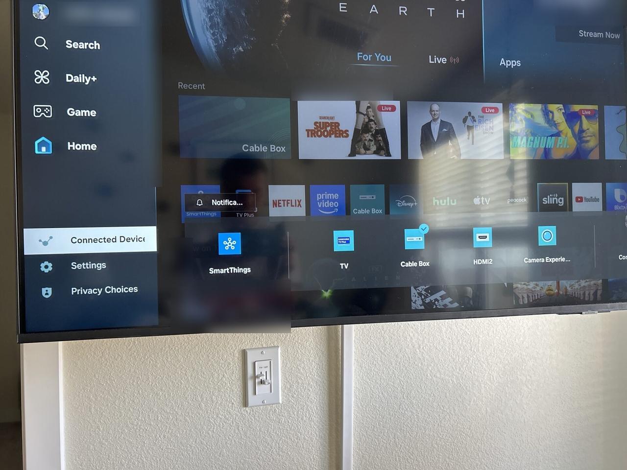 Wall-mounted TV setup and cable routing with cable routing visible documented for a smart technology service call
