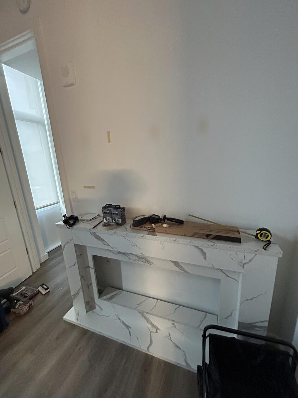 Service documentation showing display bracket or mounting preparation onsite with cable routing visible