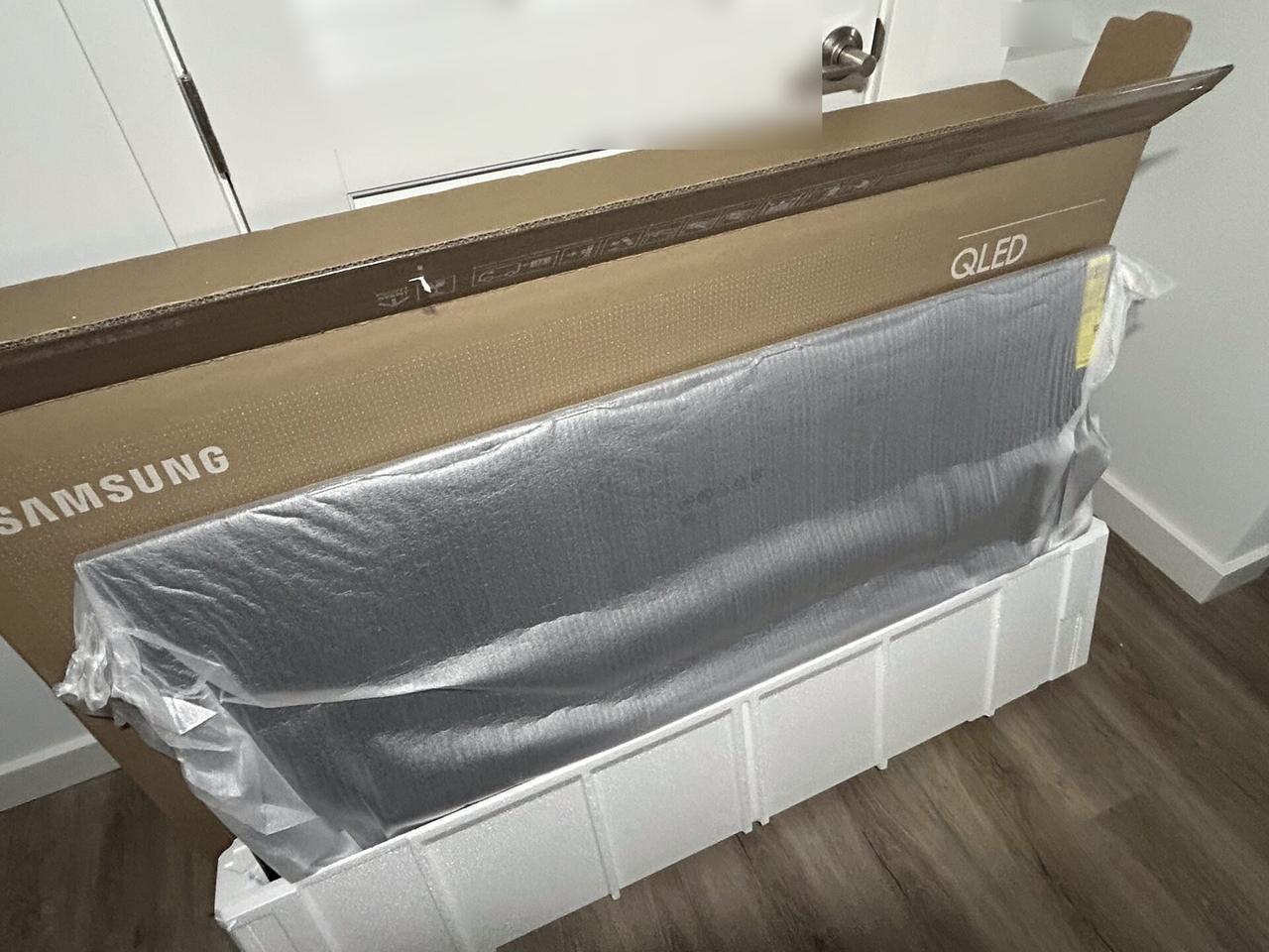 Wall-mounted TV setup and cable routing with private room details omitted documented for a smart technology service call