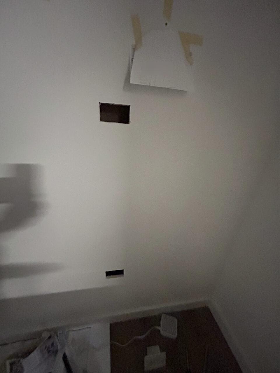 Alrty portfolio view of wall-mounted TV setup and cable routing during display setup