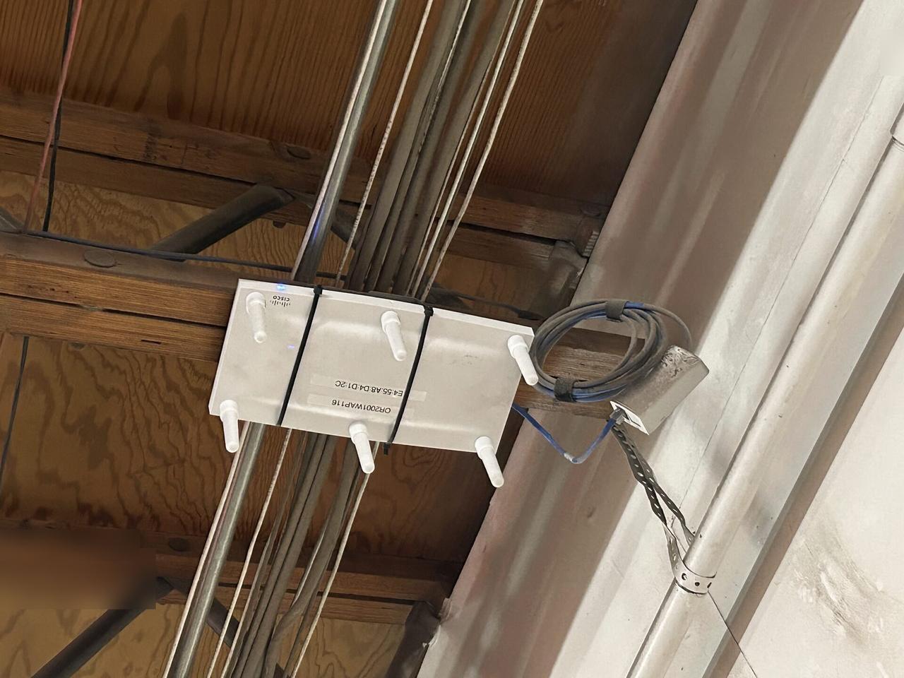 Public-safe portfolio image of enterprise retail wireless access point refresh before final network testing