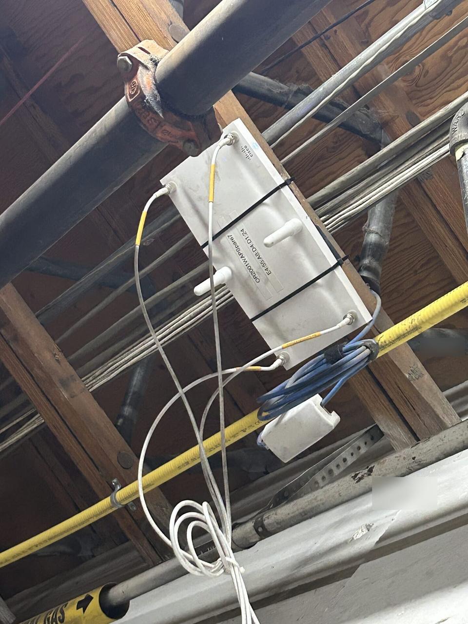 Onsite service photo showing enterprise retail wireless access point refresh with cable routing visible