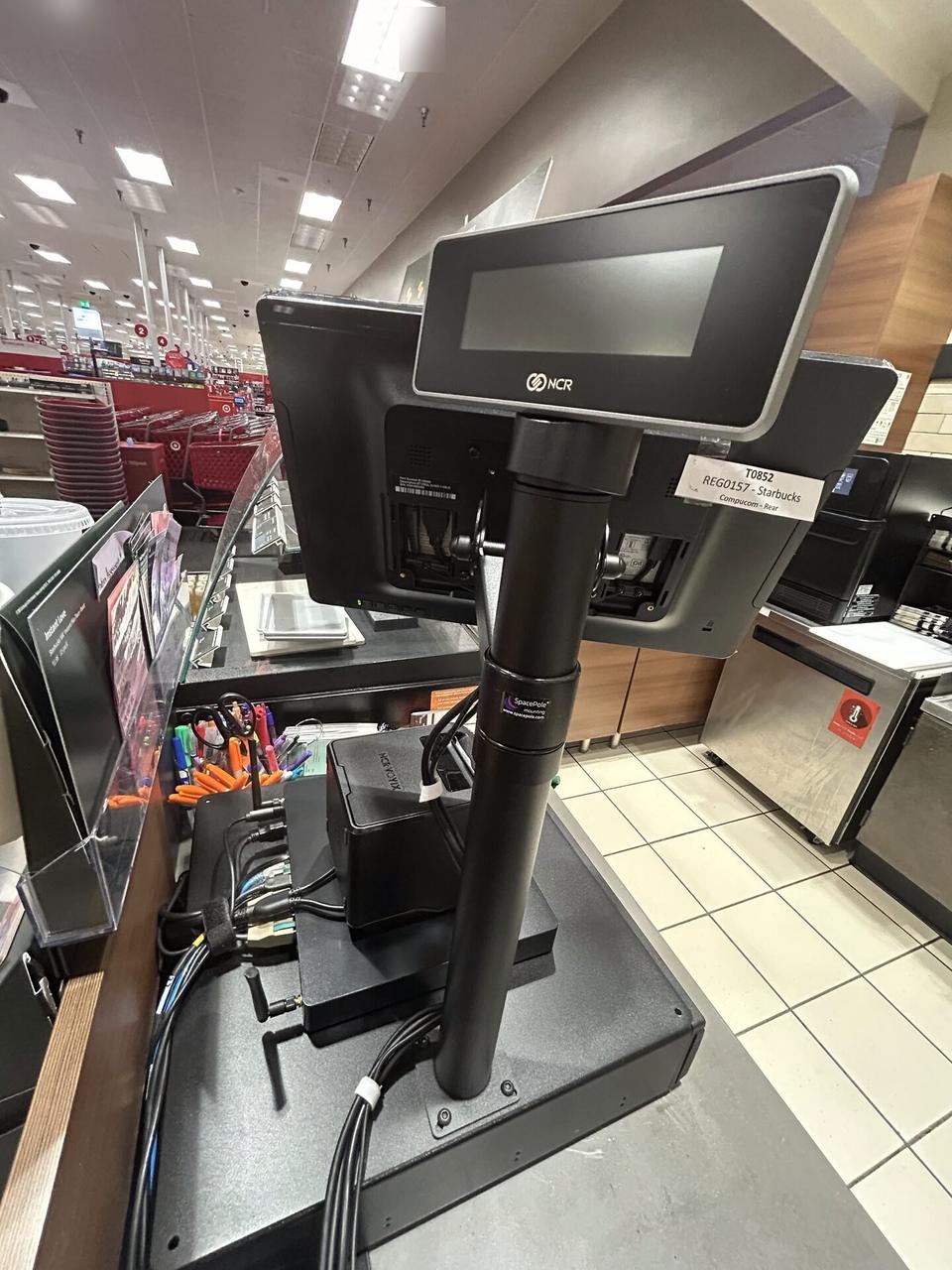 Public-safe portfolio image of register counter technology during onsite service with private labels omitted