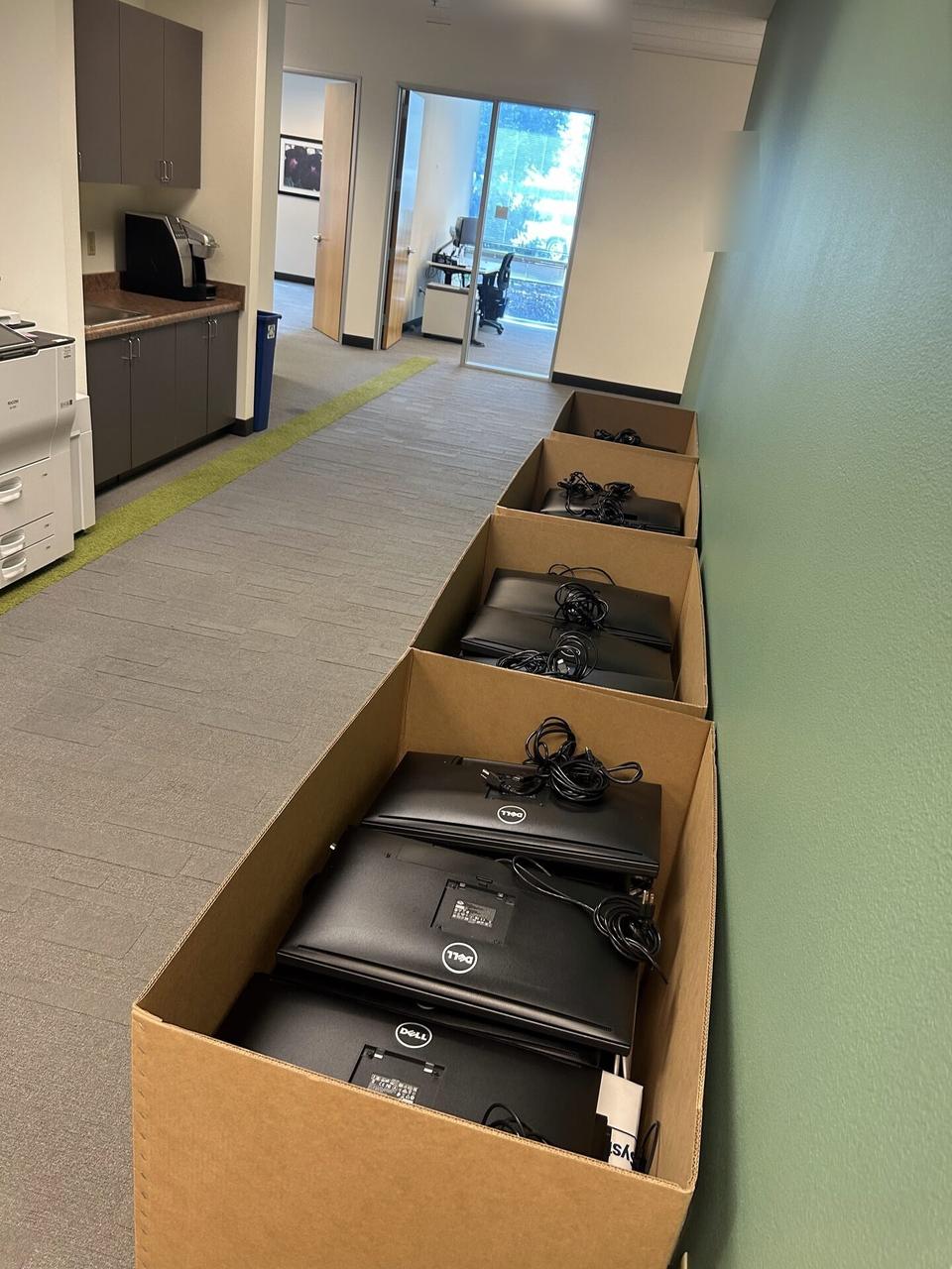 Public-safe portfolio image of office workstation setup with monitors during desk-side setup