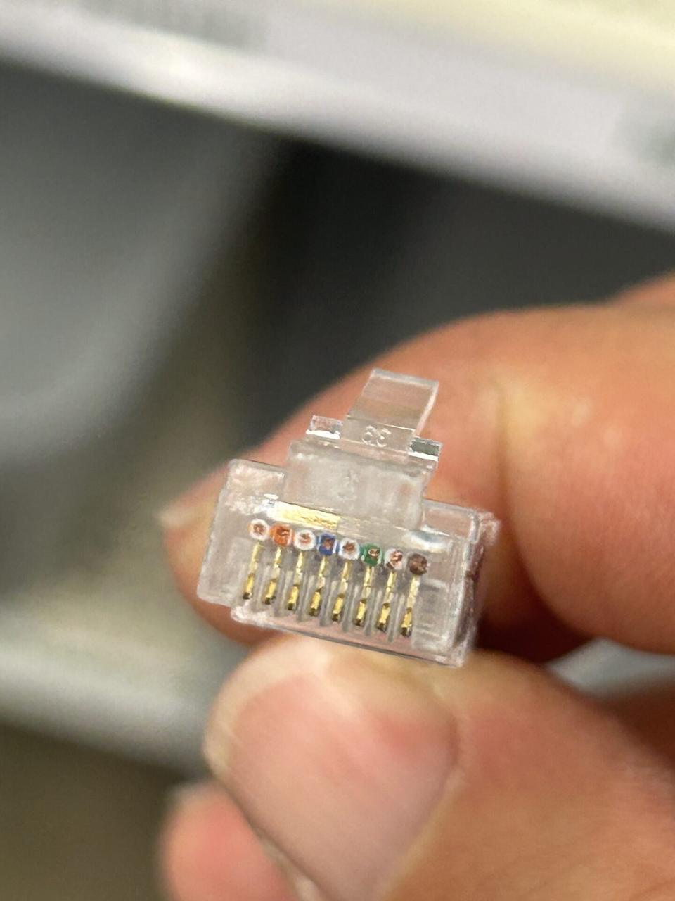 Real RJ45 connector close-up used for retail counter cable and device handoff planning