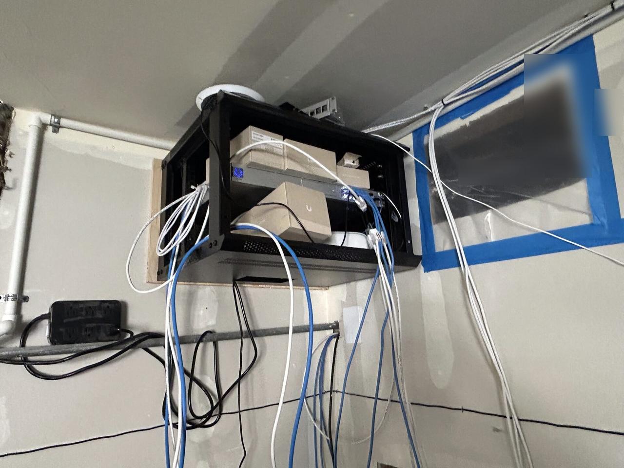 Onsite service photo showing security camera and low-voltage wiring service with private views omitted