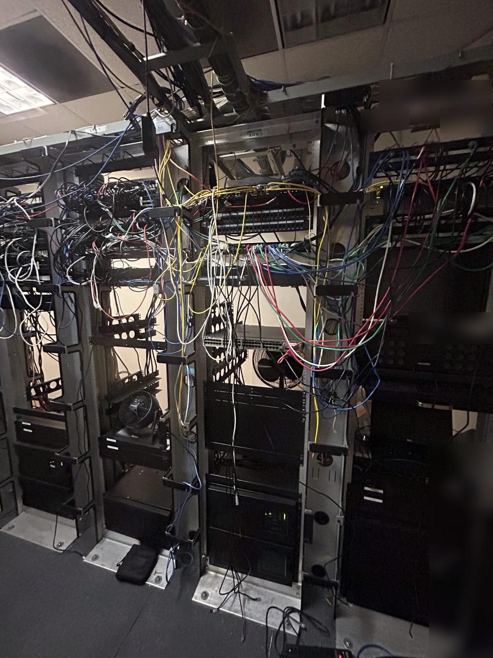 Onsite service photo showing server-room teardown and network equipment inventory