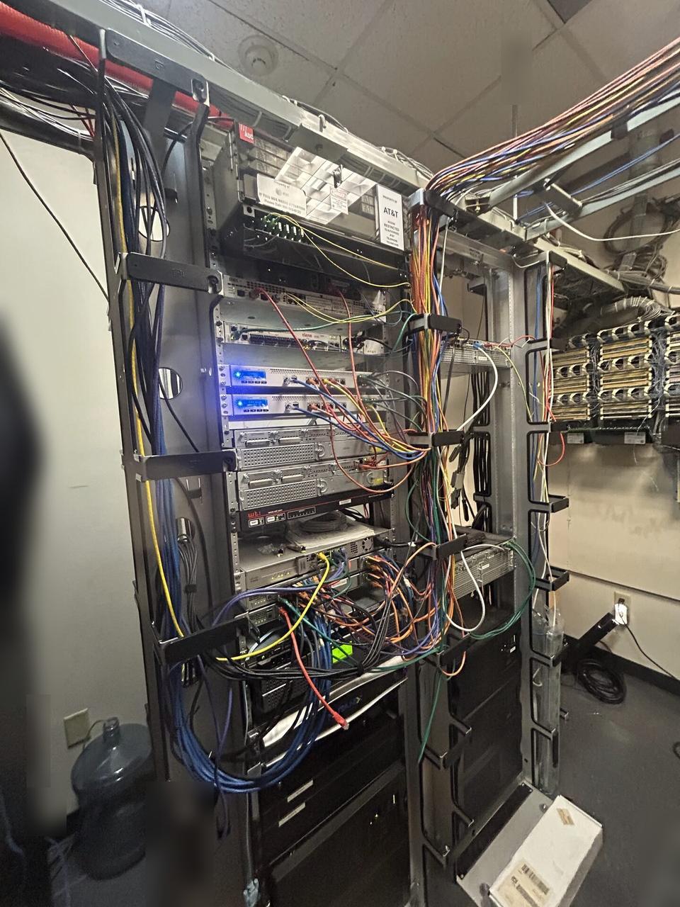 Public-safe portfolio image of server-room teardown and network equipment inventory