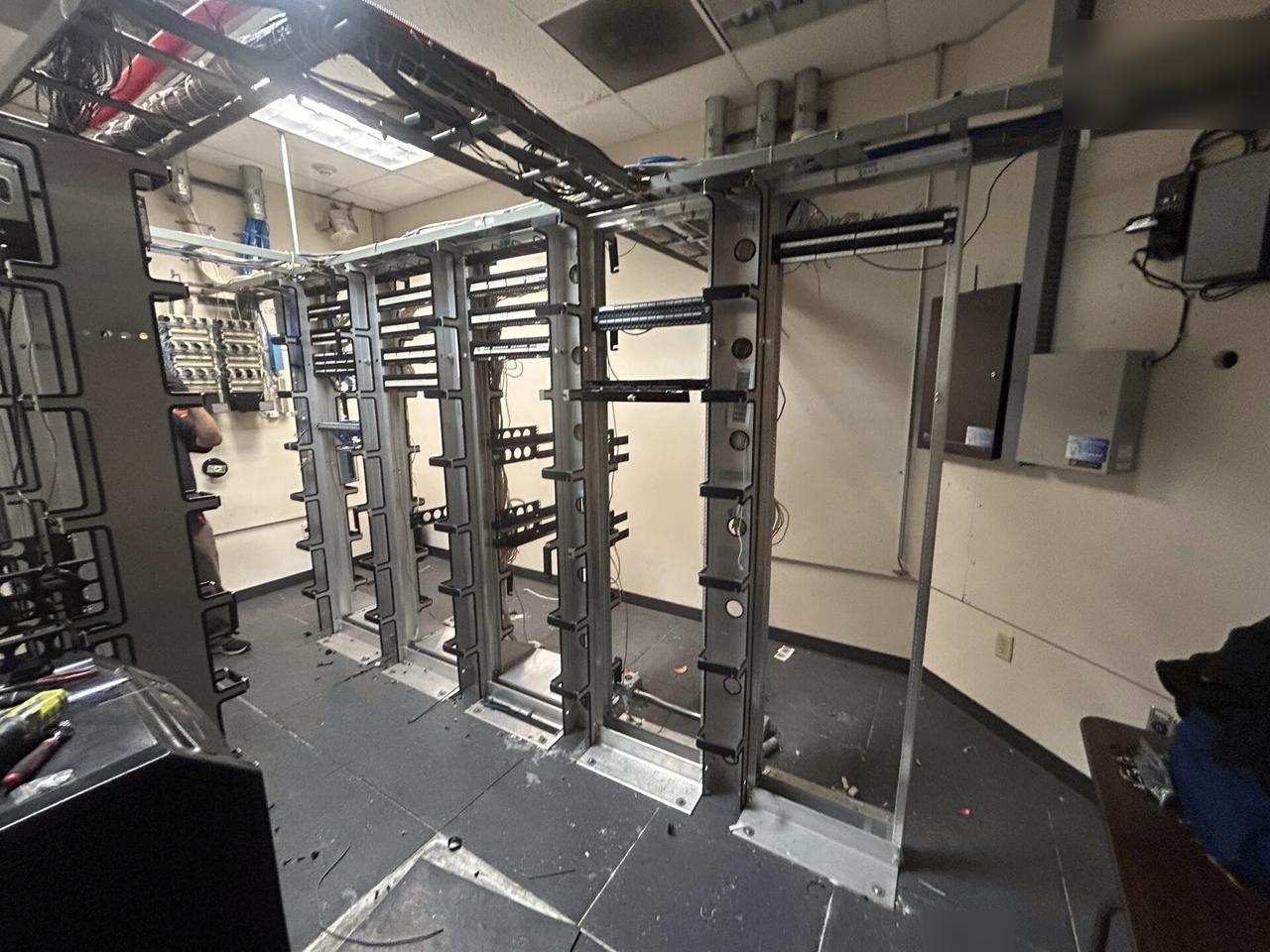 Server-room teardown and network equipment inventory documented for a smart technology service call