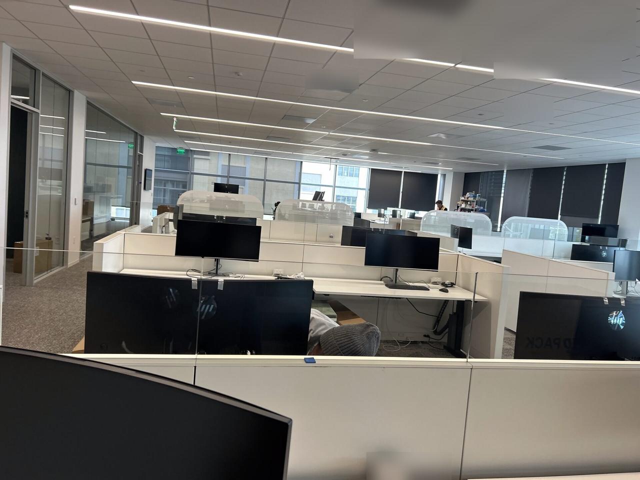 Public-safe portfolio image of office workstation setup with monitors with monitor cabling visible