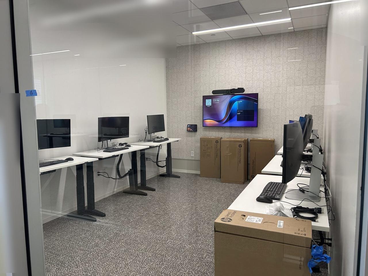 Office workstation setup with monitors with private screen details omitted during an Alrty onsite service visit