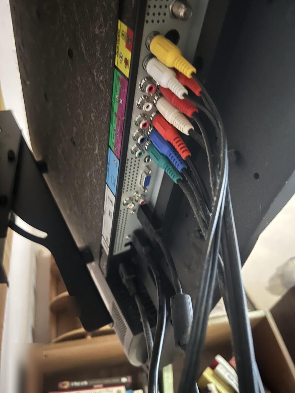 TV mounting or home theater setup detail with display placement, mount work, cabling or finished installation context