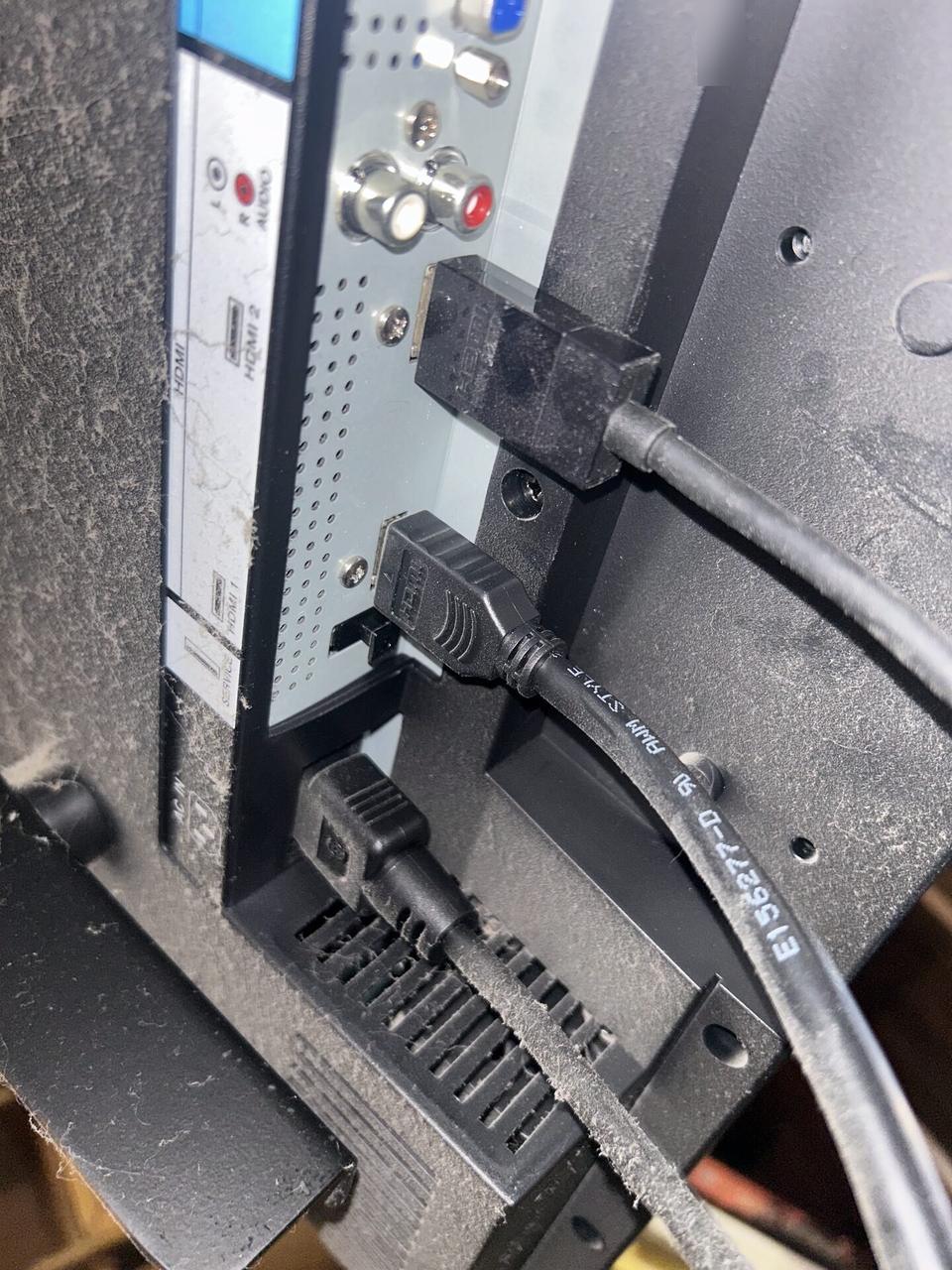 TV mounting or home theater setup detail with display placement, mount work, cabling or finished installation context