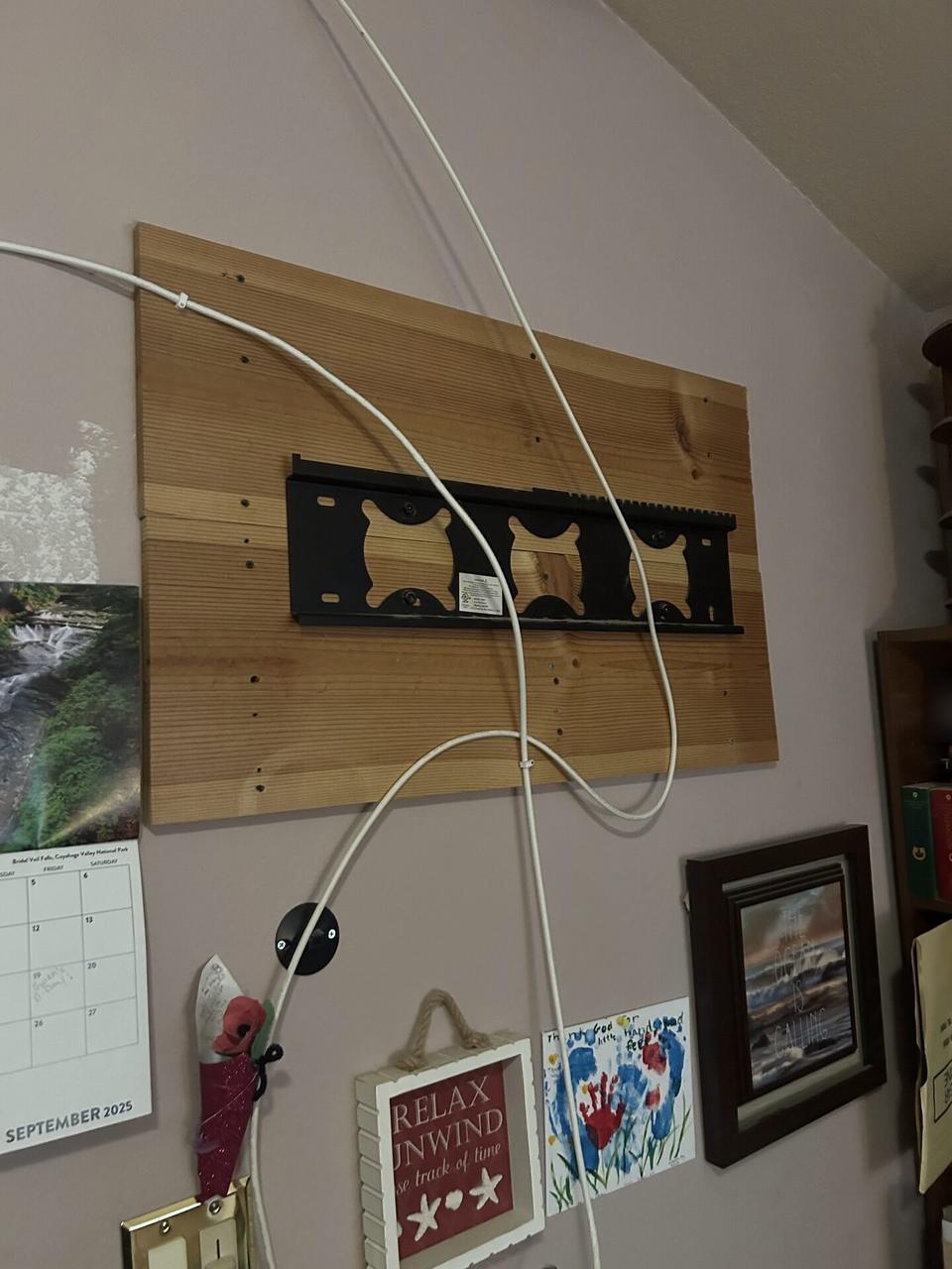 Service documentation showing display bracket or mounting preparation onsite with wall hardware context