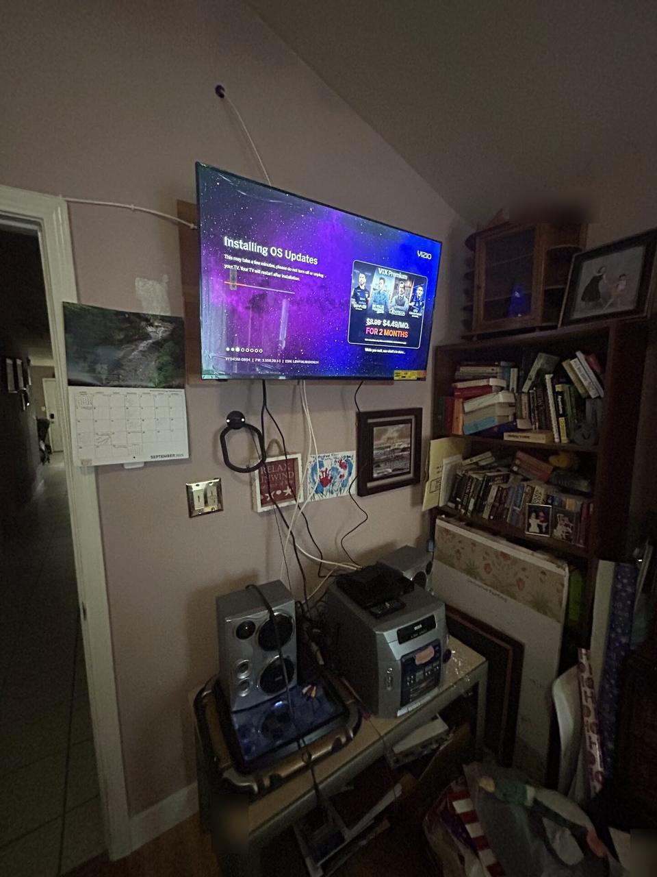 Public-safe portfolio image of wall-mounted TV setup and cable routing near the mounting location