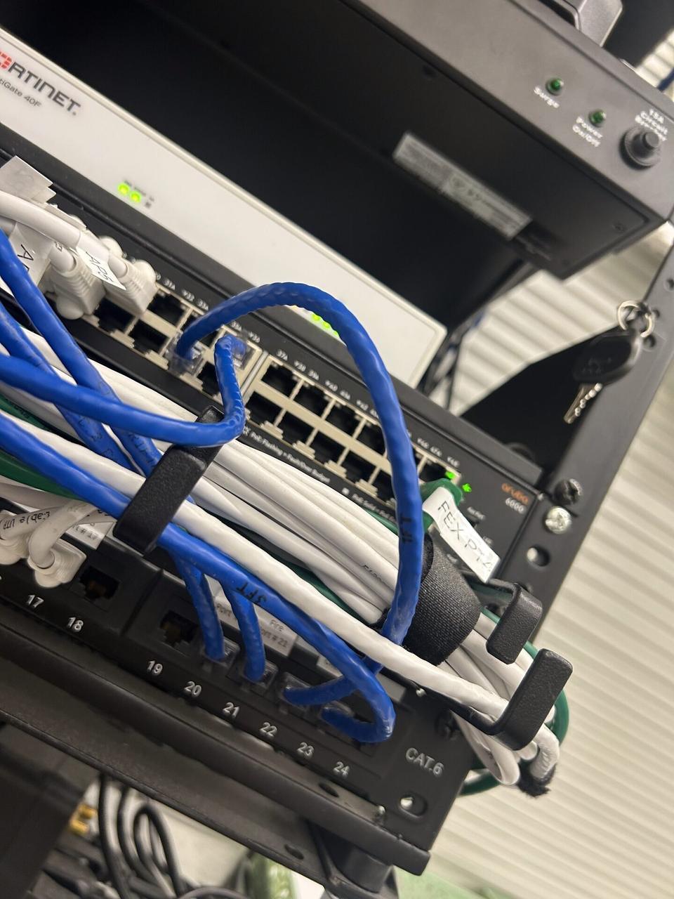 Onsite service photo showing low-voltage hardware and device cabling during cable path verification