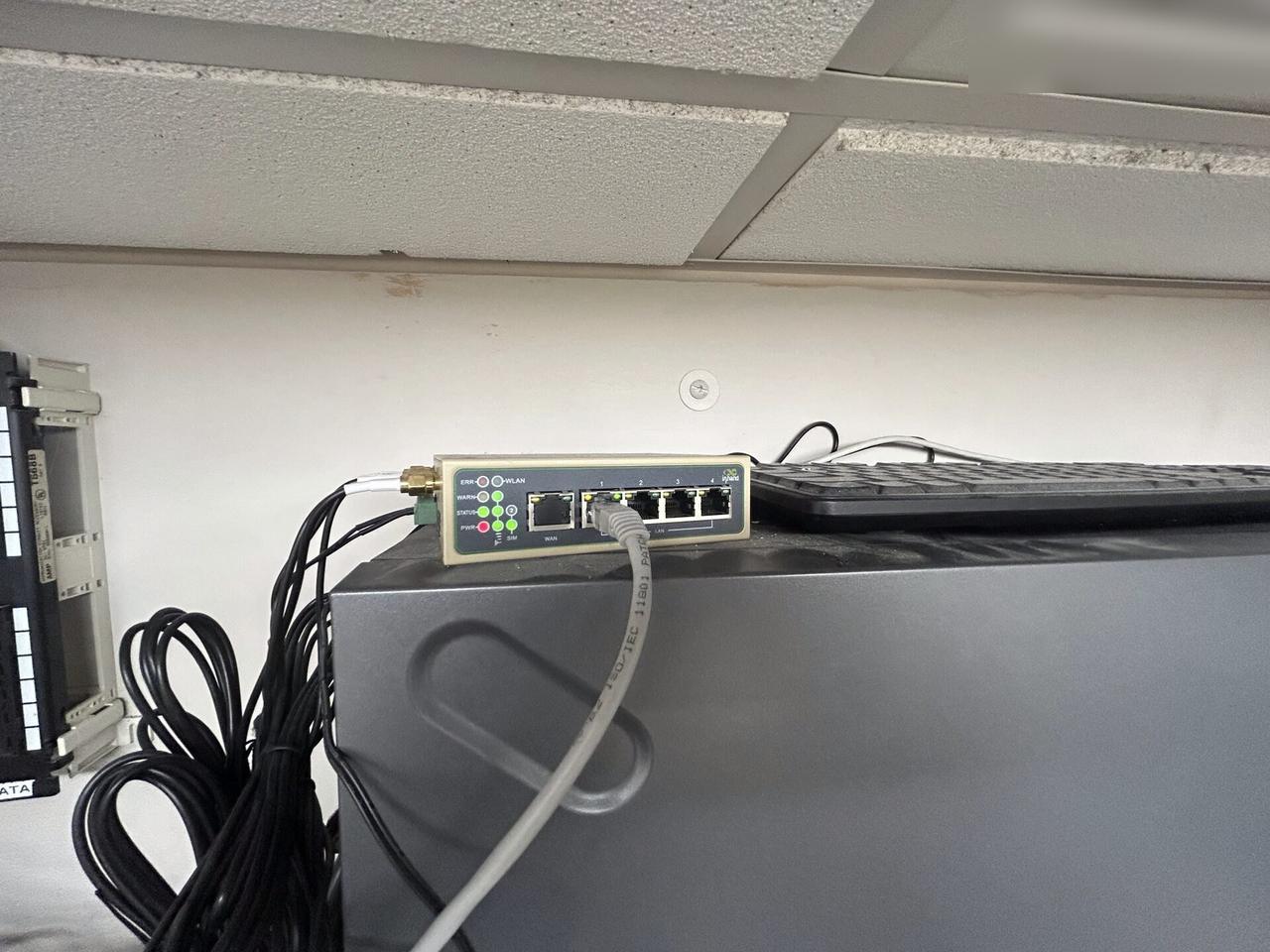 Low-voltage hardware and device cabling with wall routing visible documented for a smart technology service call