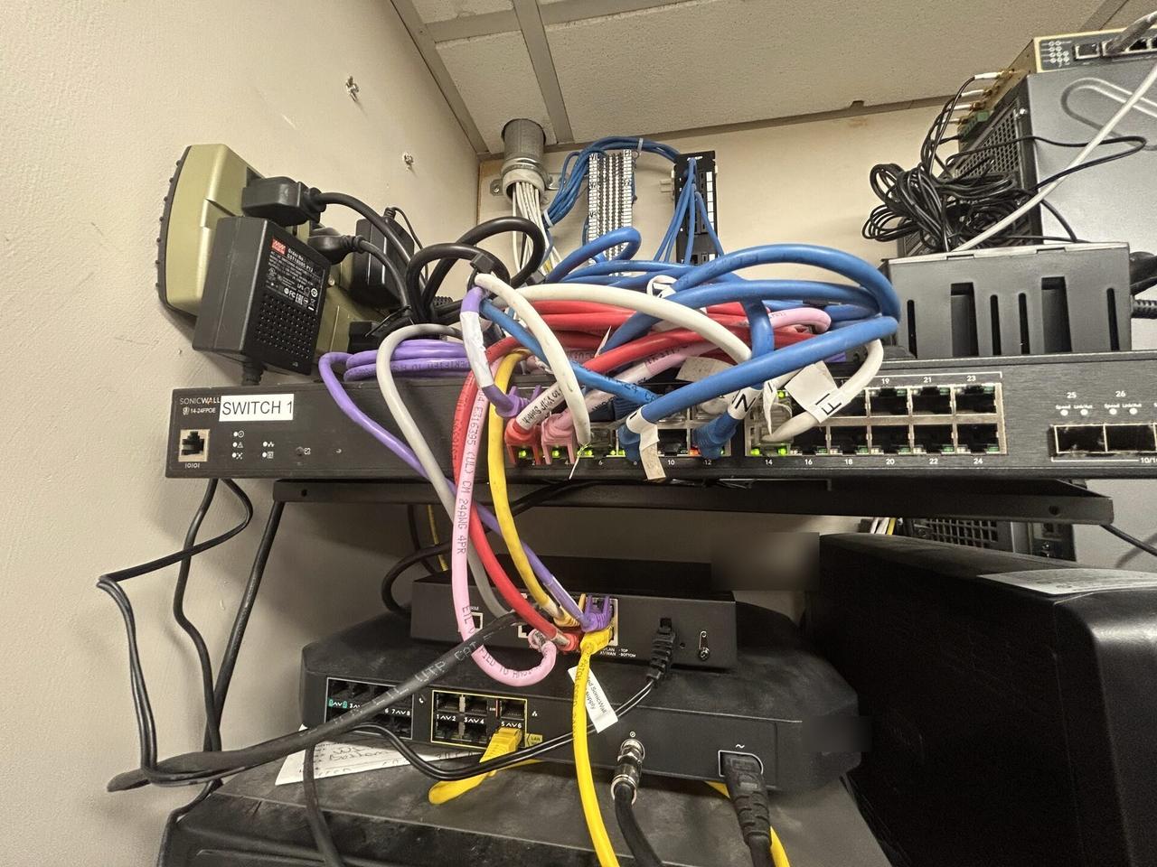 Service documentation showing equipment cabinet cabling and switch handoff with rack cabling organized